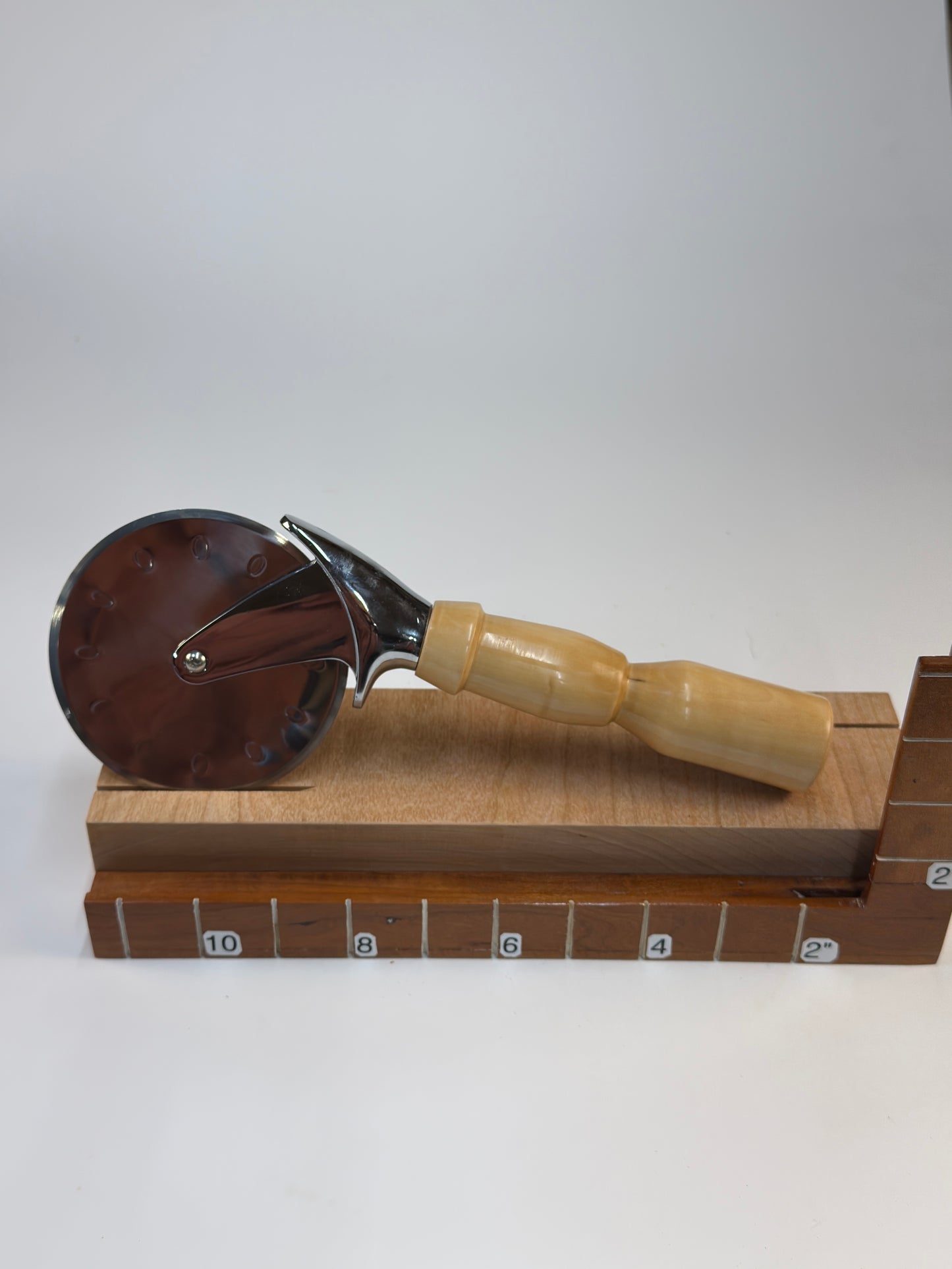 Bradford Pear Pizza Cutter — shown with scale reference