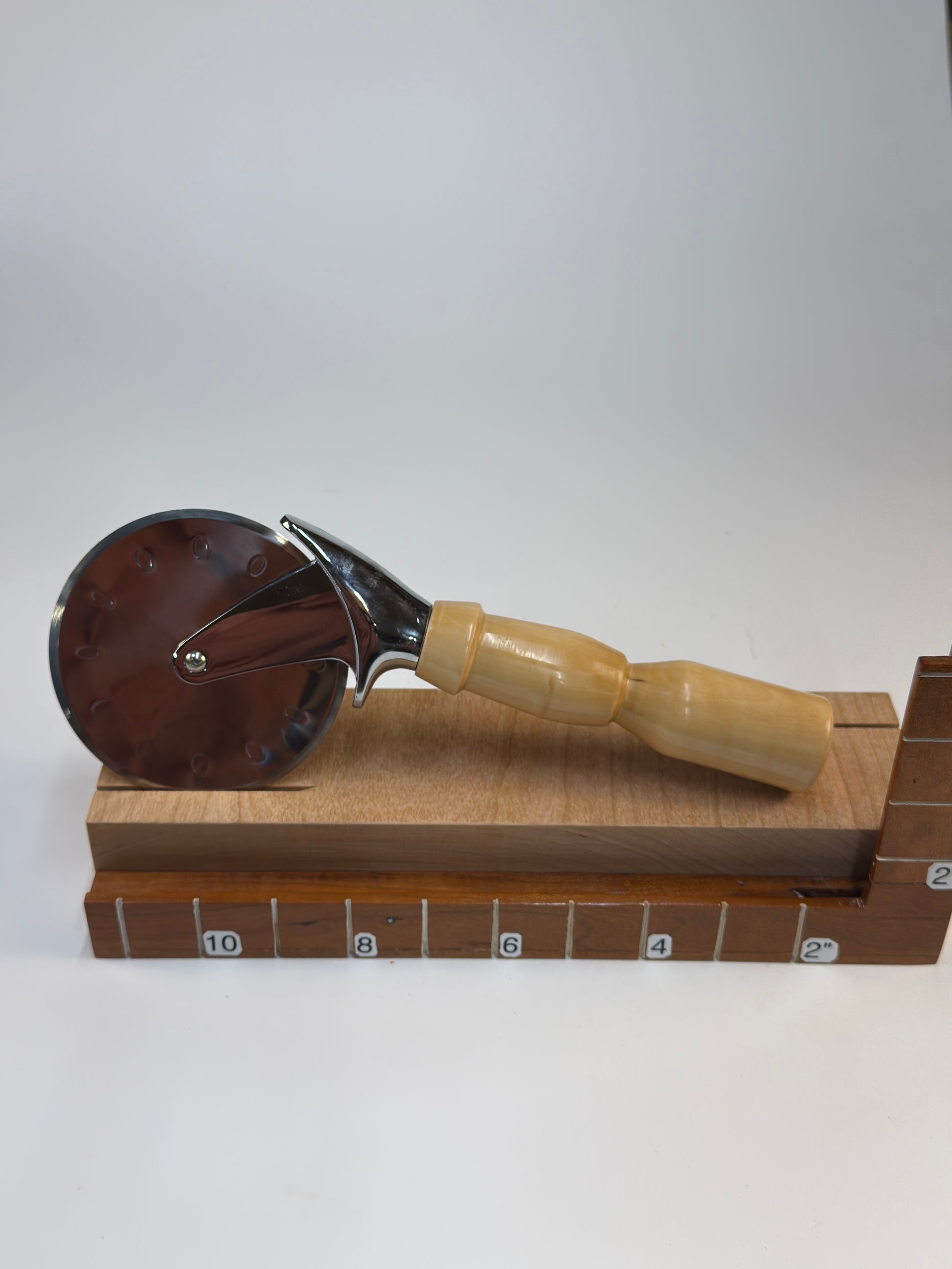 Bradford Pear Pizza Cutter — shown with scale reference