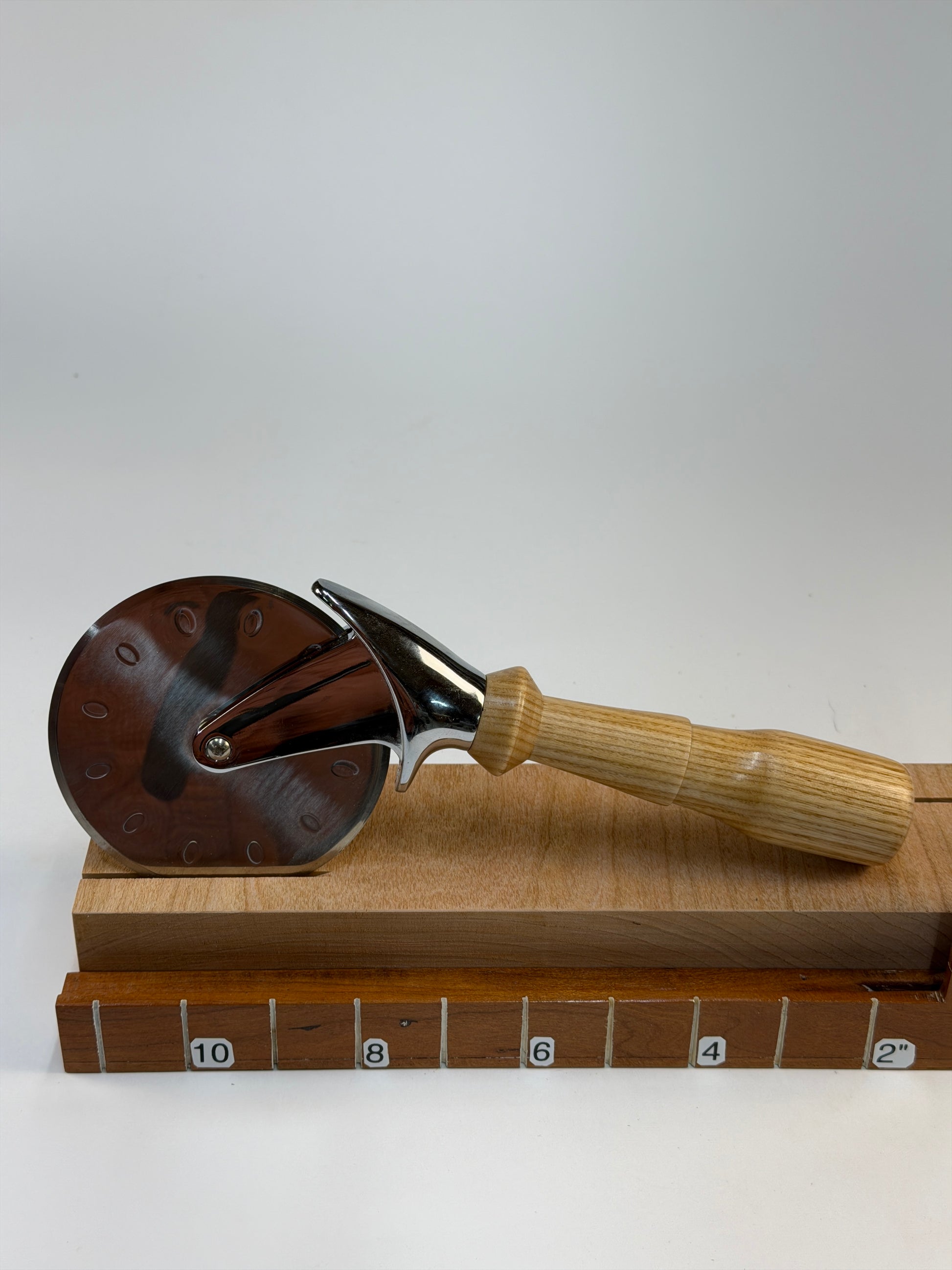 Ash Pizza Cutter — shown with scale reference