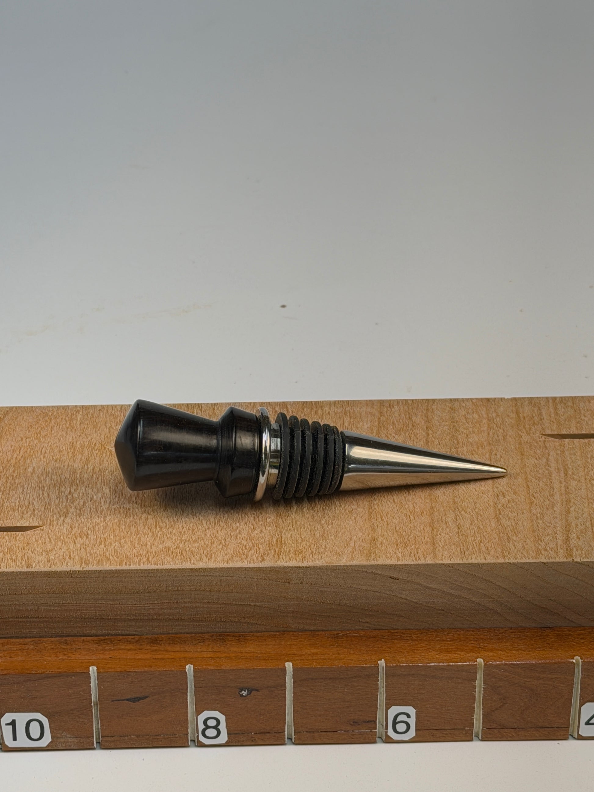 African Blackwood Bottle Stopper — shown with scale reference