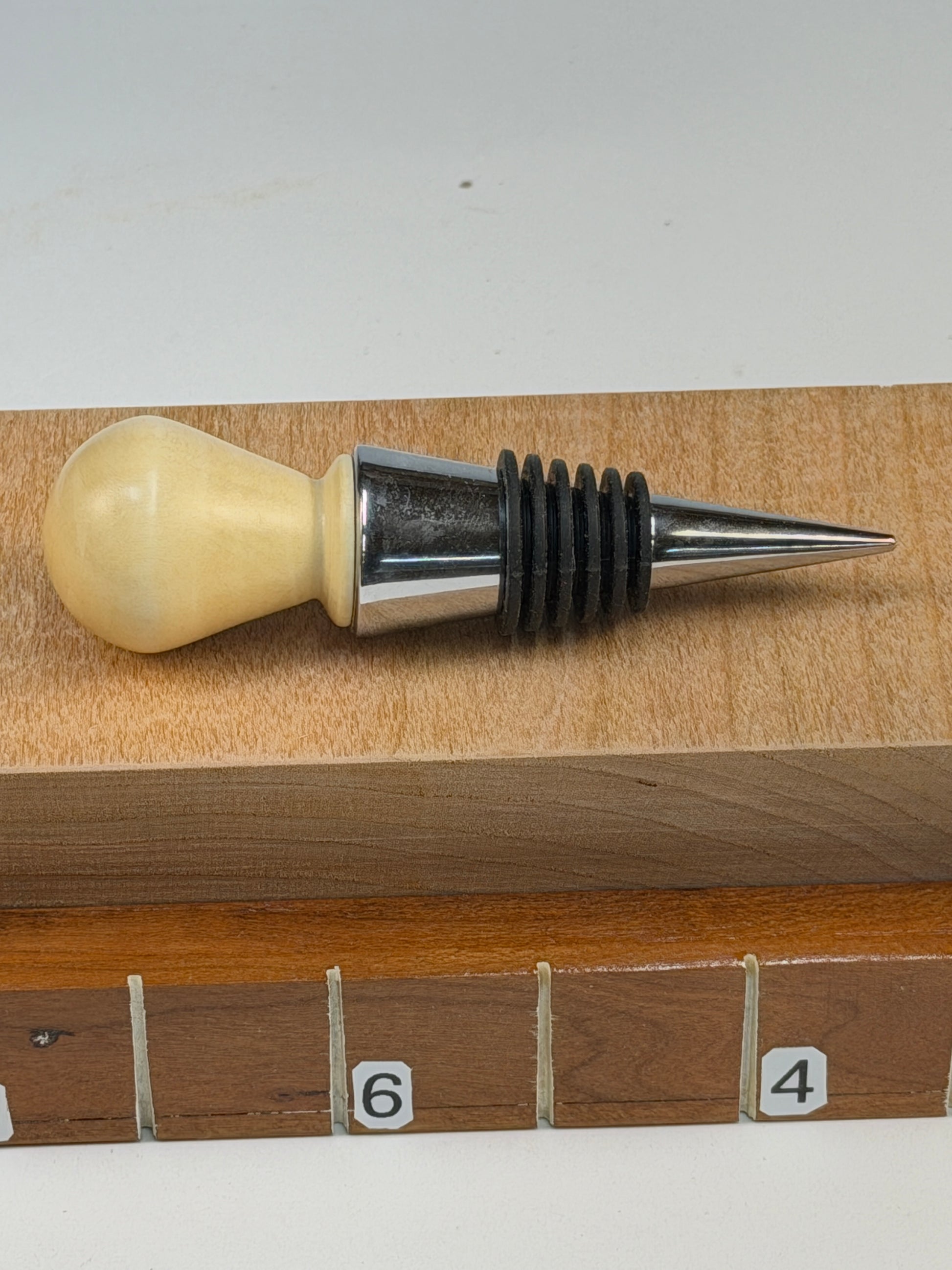 Holly Bottle Stopper — shown with scale reference